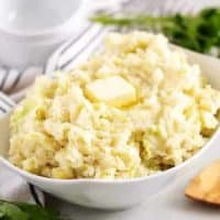 The finished colcannon recipe, in a bowl, topped with butter.
