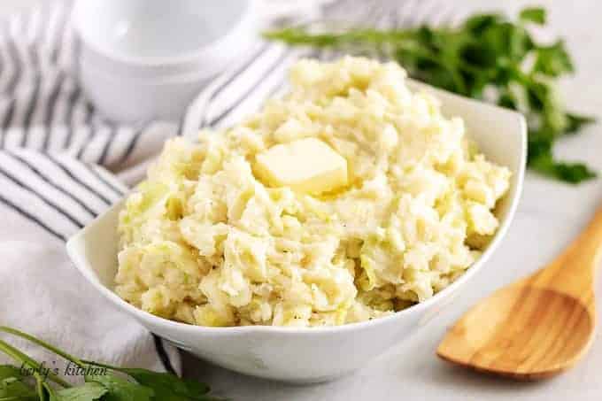 The finished colcannon recipe, in a bowl, topped with butter.