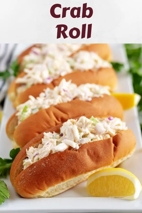 Four plated crab rolls, garnished with lemon wedges and fresh parsley.