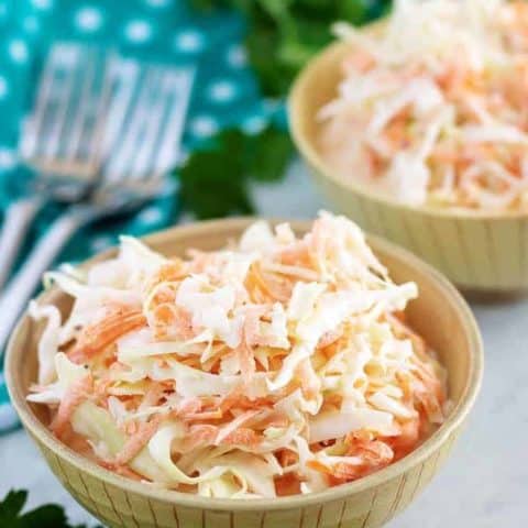 A large photo of the finished creamy coleslaw served in two bowls.