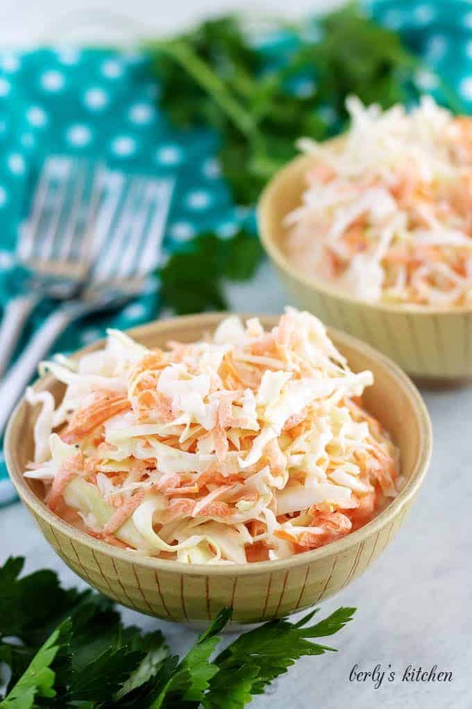 A large photo of the finished creamy coleslaw served in two bowls.