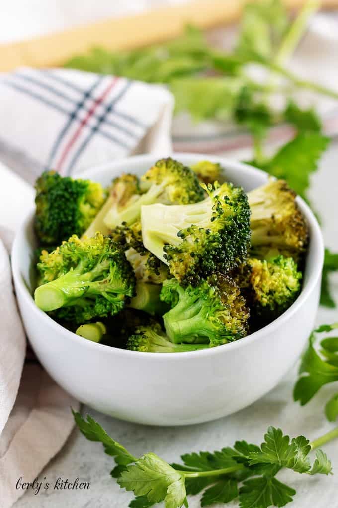 A bowl of sauteed broccoli drizzled with the wine and butter sauce.
