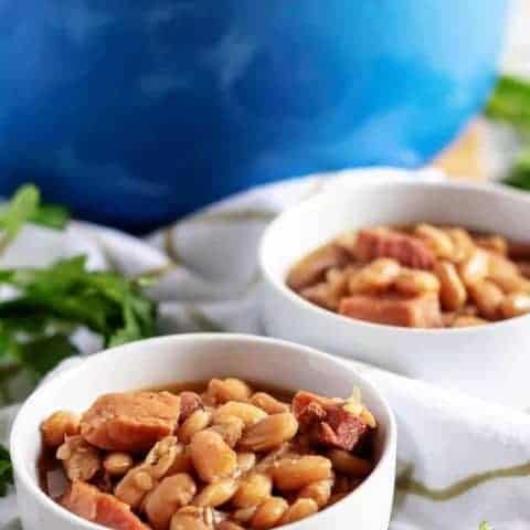 One Pot Ham And Beans Two big bowls of ham and beans sitting on a towel.