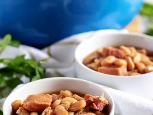 Two big bowls of ham and beans sitting on a towel.