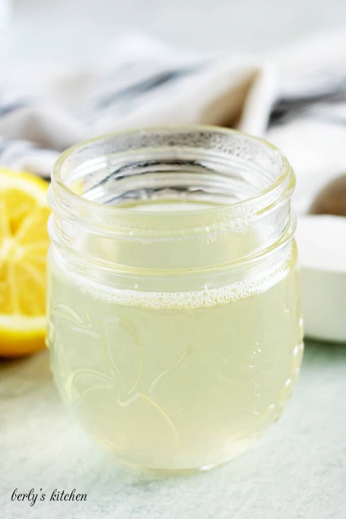 A small mason jar filled with the lemon flavored simple syrup.