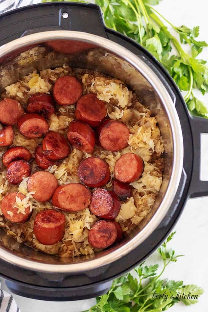 An aerial view of sauerkraut and sausage inside the Instant Pot.