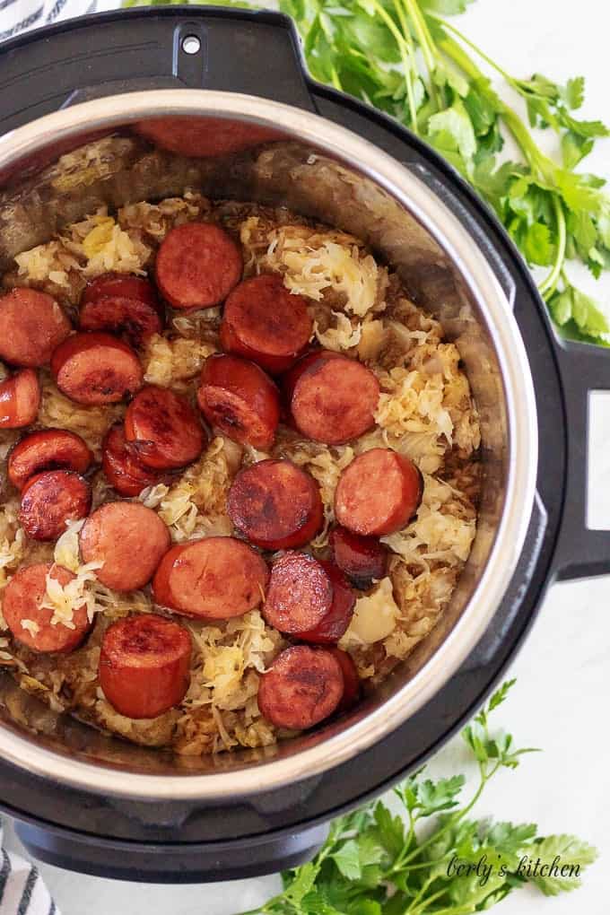 An aerial view of sauerkraut and sausage inside the instant pot.