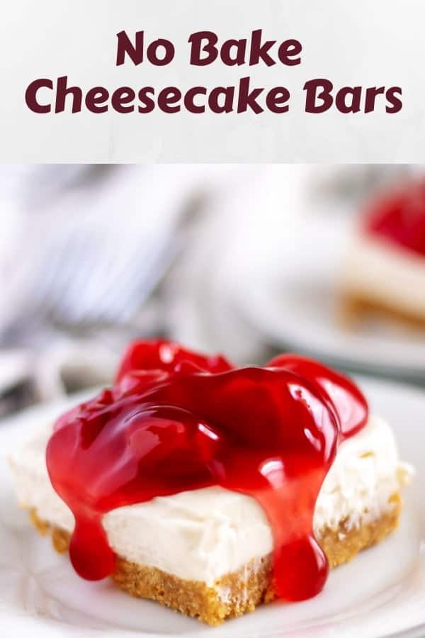 A cheesecake bar, sitting on a white plate, covered in cherry topping.