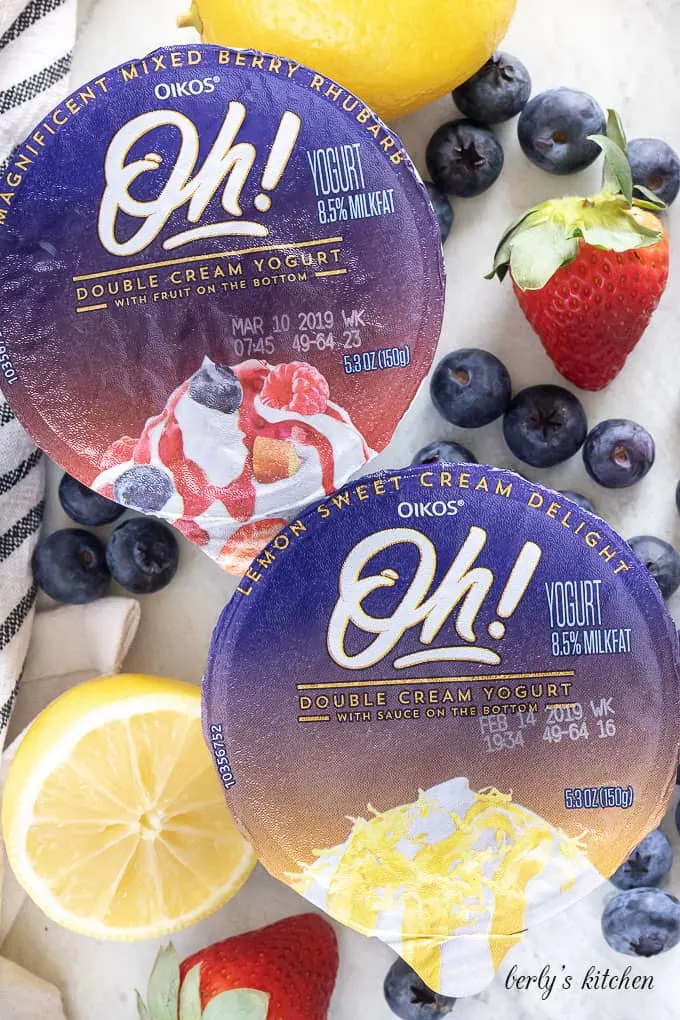 Top-down shot of the unopened lemon and mix berry yogurts.