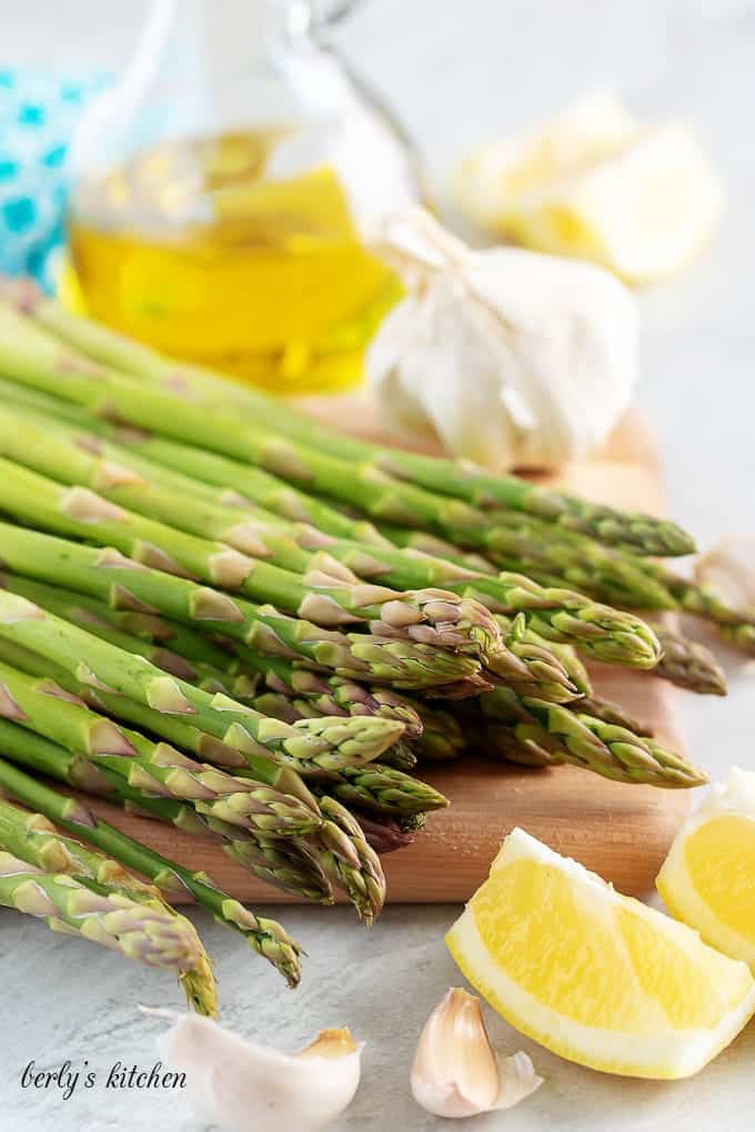 The side dish ingredients like asparagus, garlic, lemon juice, and oil.