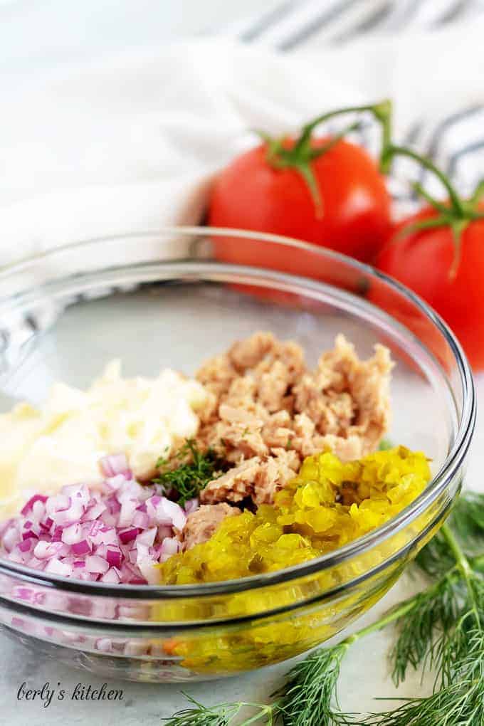 The tuna salad ingredients in a large mixing, just before stirring.