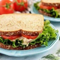 The tuna salad sandwich served on wheat bread with lettuce and tomato.