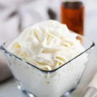 A close up shot of the amaretto whipped cream in a bowl.