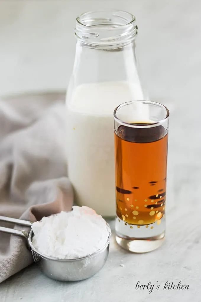 A photo showing the heavy cream, amaretto liqueur, and powdered sugar.