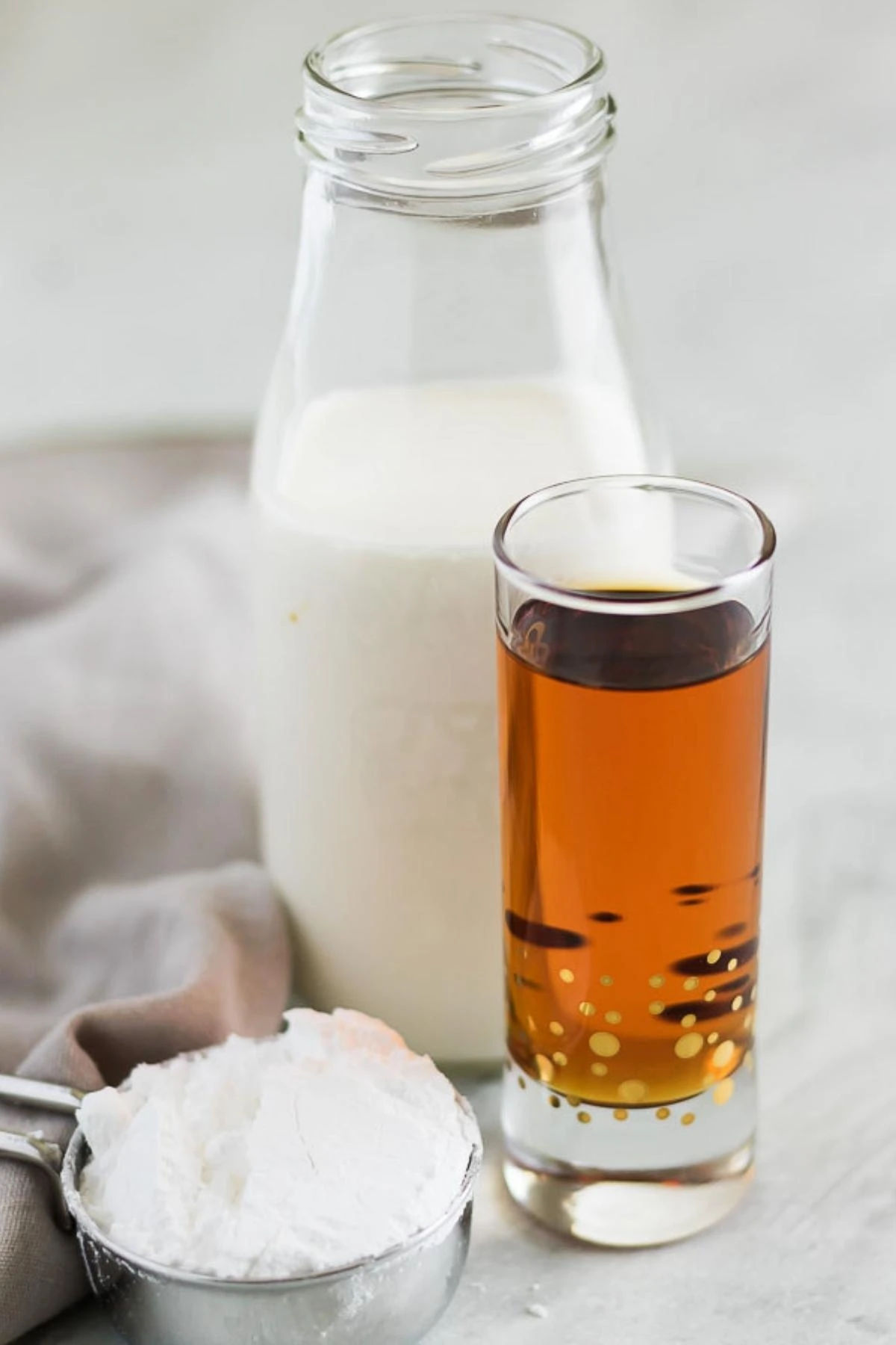 A photo showing the heavy cream, amaretto liqueur, and powdered sugar.
