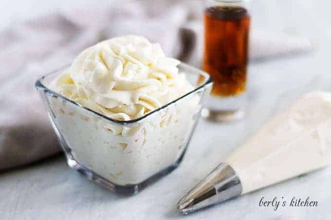 A square glass dish filled with the finished amaretto whipped cream recipe.