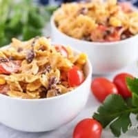 Two bowls of Southwest pasta salad accented with fresh grape tomatoes.