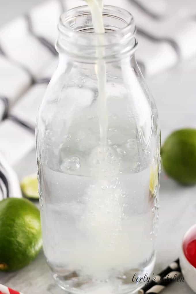 The lime soda has been prepped in a tall jar.
