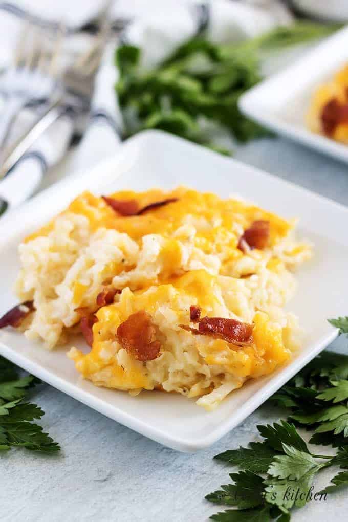 A portion of the hash brown casserole on a square plate.