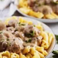 A close-up picture of the meatballs and mushrooms covered in gravy.