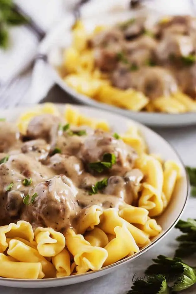 A close-up picture of the meatballs and mushrooms covered in gravy.
