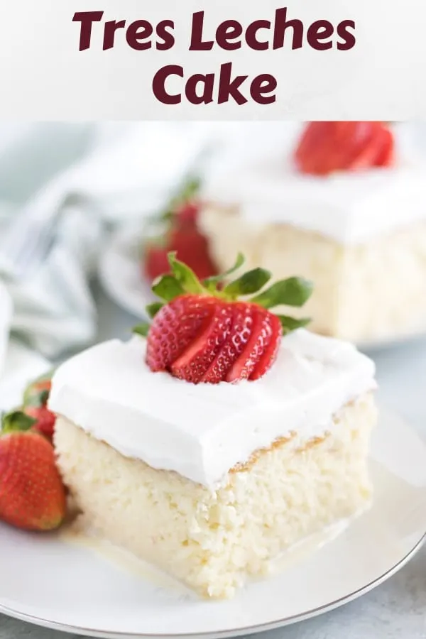 A piece of tres leches cake garnished with a strawberry.