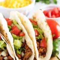 A final picture of the turkey tacos sitting on a cutting board.