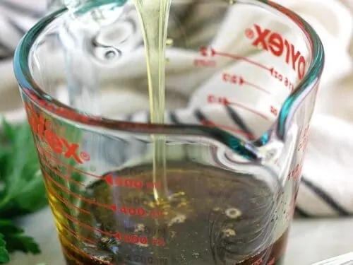 A tablespoon of honey being added to the soy sauce.