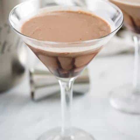 Double Chocolate Martini Recipe Two chocolate martinis in martini glasses on a marble table top.
