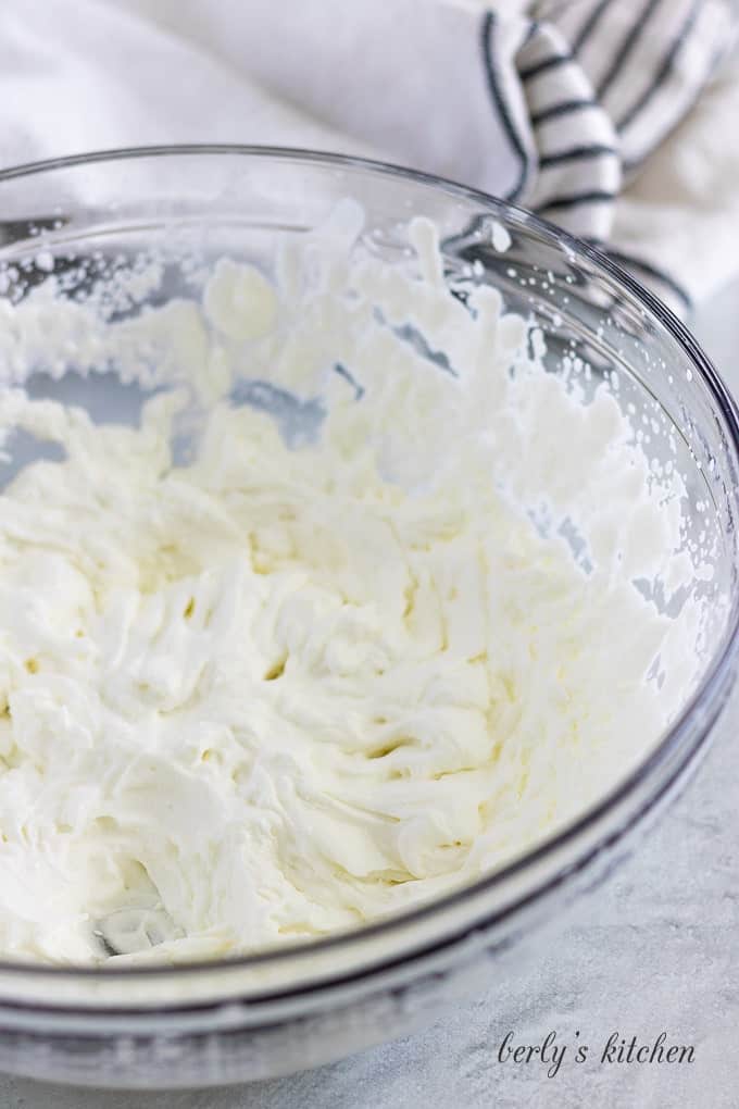 The cream, sugar, and vanilla have been whipped until peaks formed.