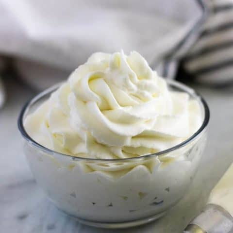 Large photo of the finished homemade whipped cream in a ramekin.
