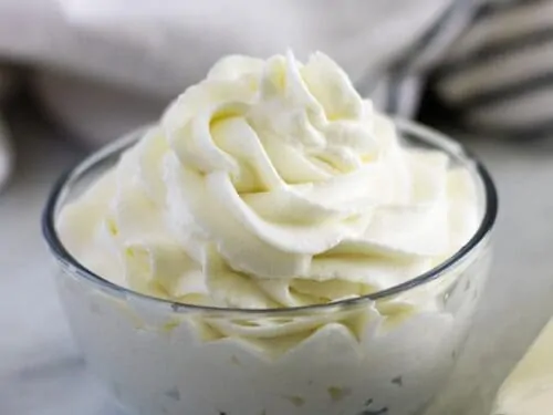Large photo of the finished homemade whipped cream in a ramekin.