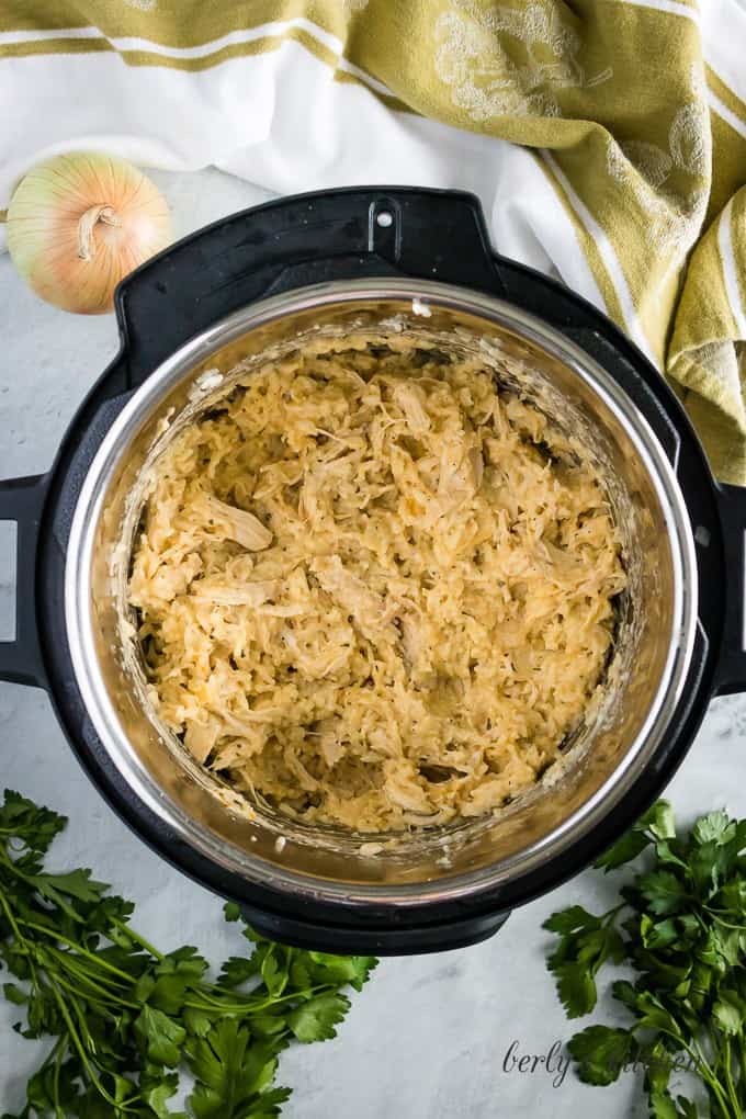 Shredded cheese and heavy cream have been added to the pot.