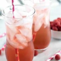 Two glasses of finished Italian soda served with ice and a straw,