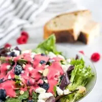 Raspberry vinaigrette over a of spring mix topped with feta cheese.