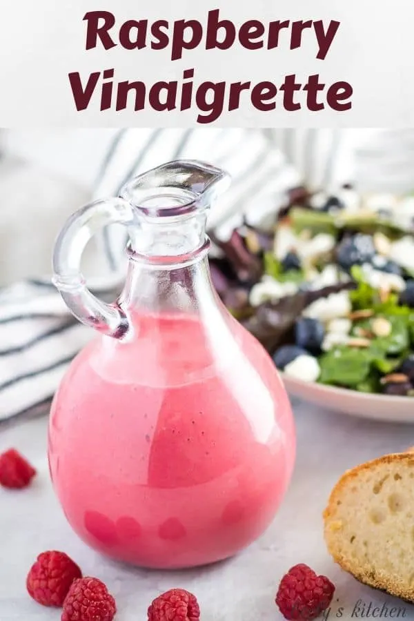 The bright homemade raspberry vinaigrette in a sealed dressing bottle.