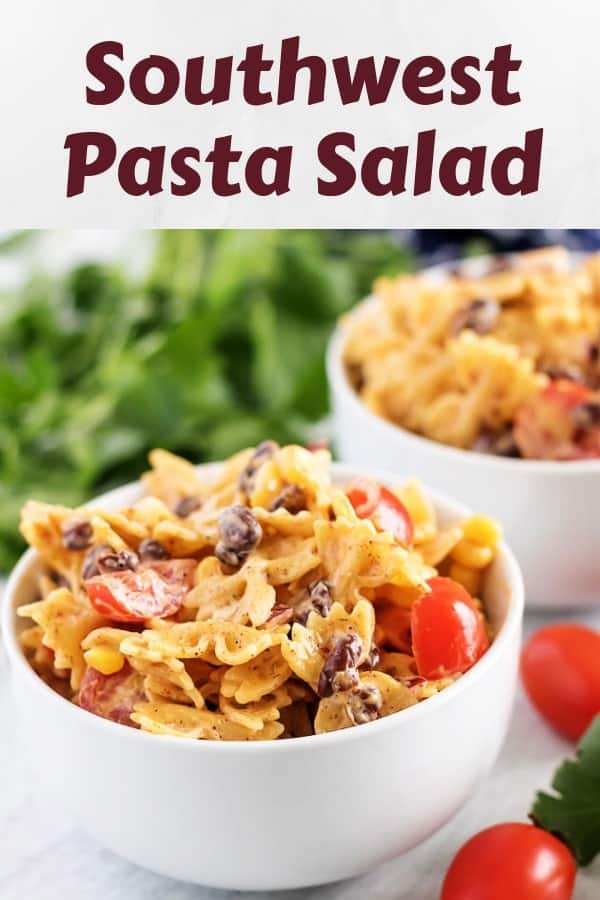 Two bowls of southwest pasta salad garnished with fresh grape tomatoes.