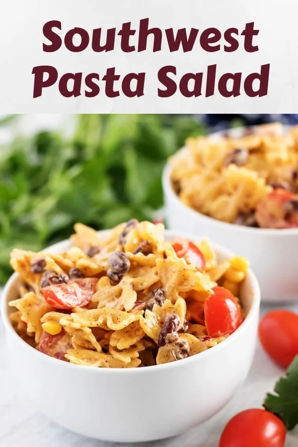 Two bowls of southwest pasta salad garnished with fresh grape tomatoes.