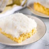 A large slice of the coconut cake on a small white plate.