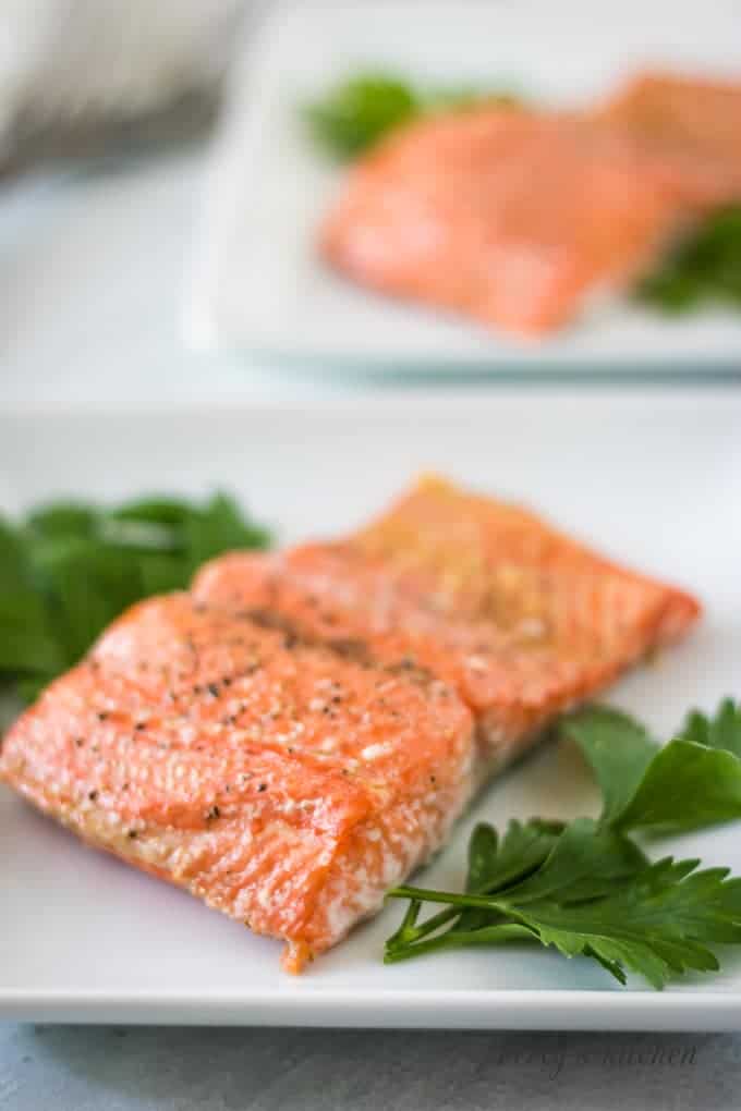 The fish has baked and has been placed on a serving plate.