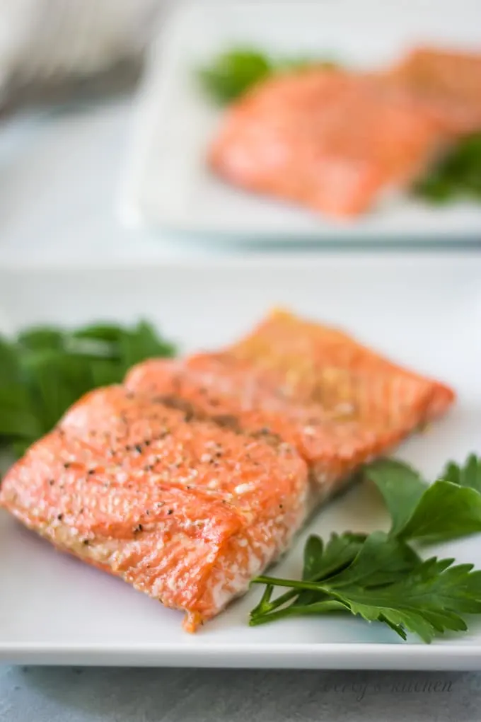 The fish has baked and has been placed on a serving plate.