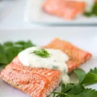 The last photo shows the finished salmon on a plate with sauce.
