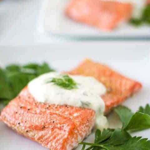 The last photo shows the finished salmon on a plate with sauce.
