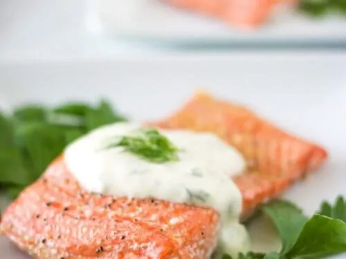 The last photo shows the finished salmon on a plate with sauce.
