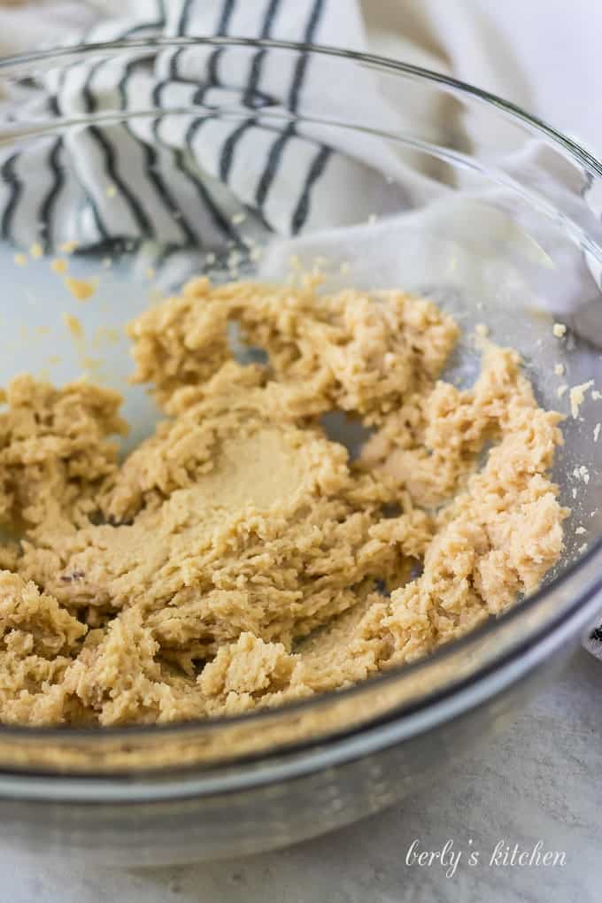 Softened butter, brown sugar, and granulated sugar creamed together in a bowl.