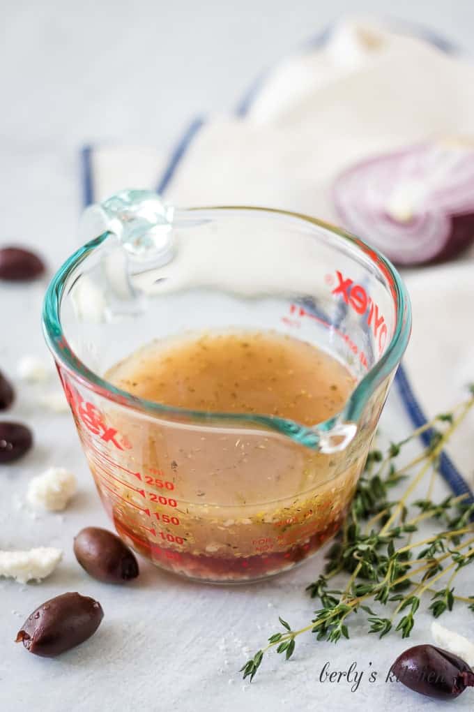 The greek salad dressing after it's been whisked in the measuring cup.