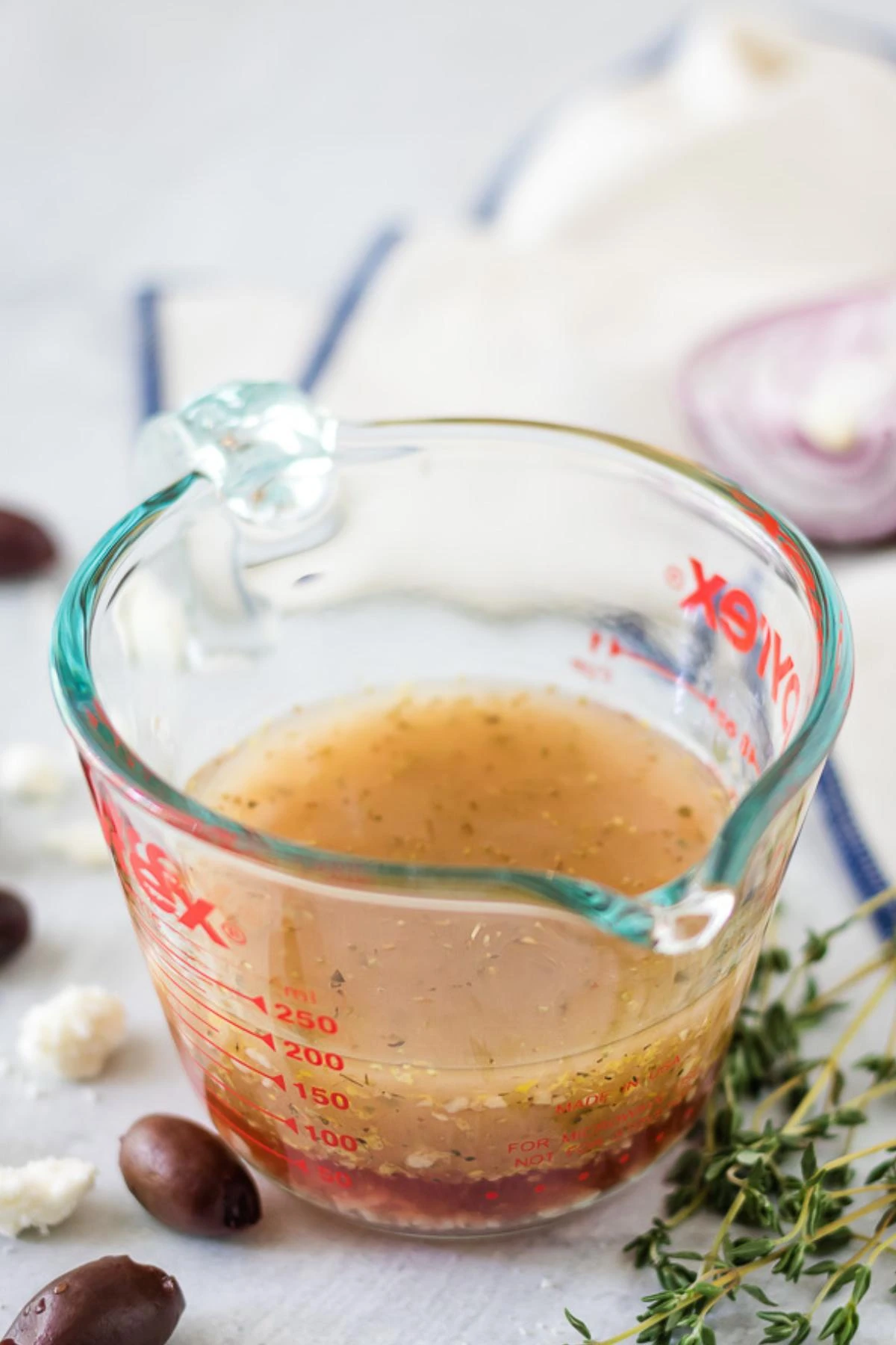 The Greek salad dressing after it's been whisked in the measuring cup.