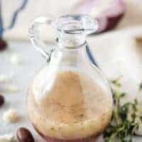 The salad dressing sitting in a dressing bottle ready to be poured.