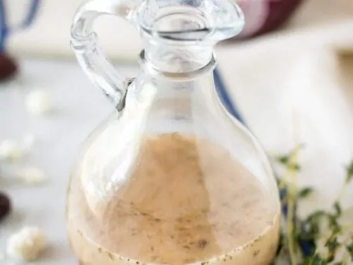 The salad dressing sitting in a dressing bottle ready to be poured.
