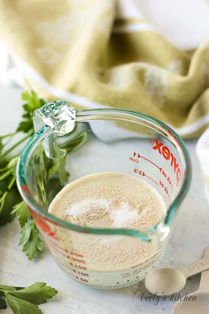 Yeast, sugar, and water in a measuring cup.